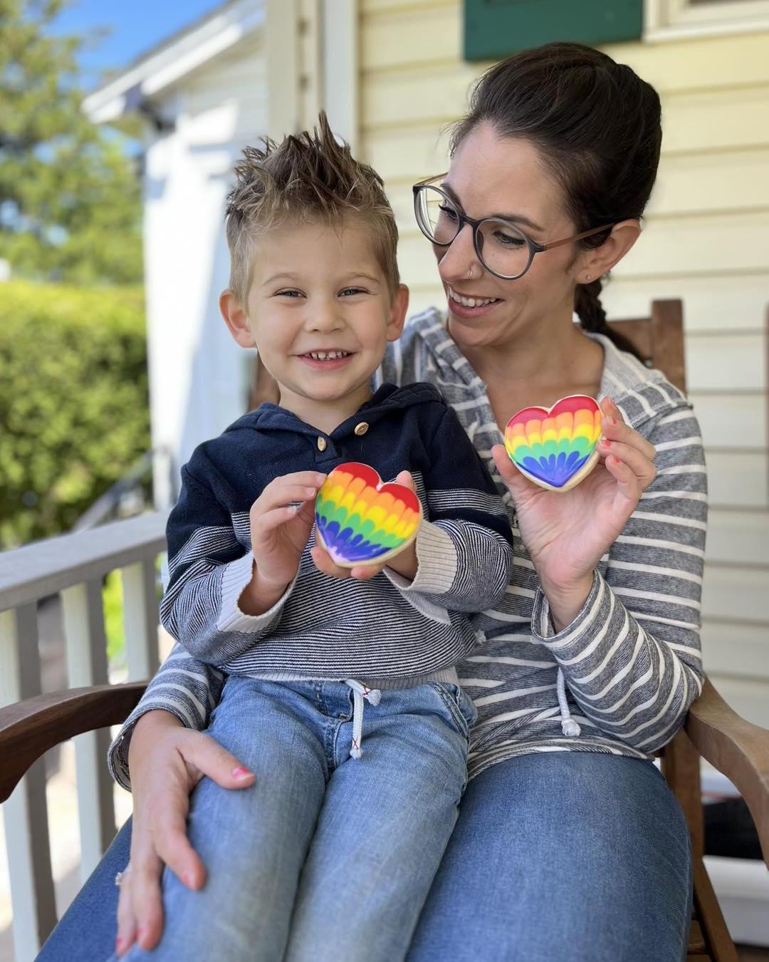 Home baker sitting on a porch with young child holding a cookie